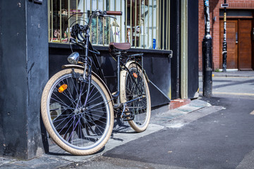 Naklejka na ściany i meble Bicycle leaning against a shop window
