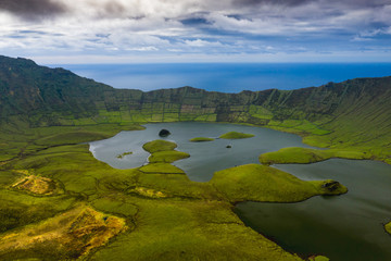 Aerial view of volcanic crater (Caldeirao) with a beautiful lake on the top of Corvo island. Azores islands, Portugal. © Curioso.Photography