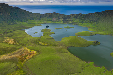 Naklejka na ściany i meble Aerial view of volcanic crater (Caldeirao) with a beautiful lake on the top of Corvo island. Azores islands, Portugal.