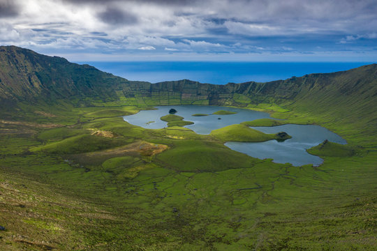 Aerial view of volcanic crater (Caldeirao) with a beautiful lake on the top of Corvo island. Azores islands, Portugal.