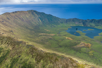 Aerial view of volcanic crater (Caldeirao) with a beautiful lake on the top of Corvo island. Azores islands, Portugal.