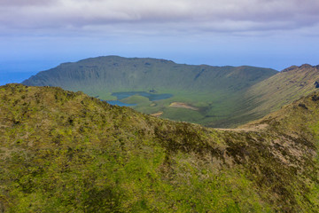 Fototapeta premium Aerial view of volcanic crater (Caldeirao) with a beautiful lake on the top of Corvo island. Azores islands, Portugal.