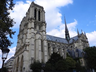 Fototapeta na wymiar The facade of Notre Dame against the blue sky.