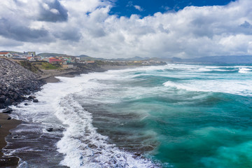 Aerial view of Atlantic coast at Ribeira Grande. Blue water and clouds. Island of Sao Miguel, Azores Islands, Portugal, Europe.