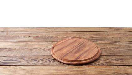 Round pizza food cutting board on brown wooden table isolated on white background. Wood tray plate and table top view. Empty copy space. Selective focus. Banner