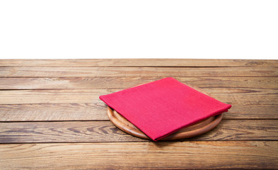Round pizza food cutting board and table cloth red napkin on brown wooden table isolated on white background. Wood tray plate and table top view. Empty copy space. Selective focus. Banner
