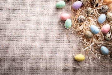 Fototapeta na wymiar Easter, colorful quail eggs on a linen background.