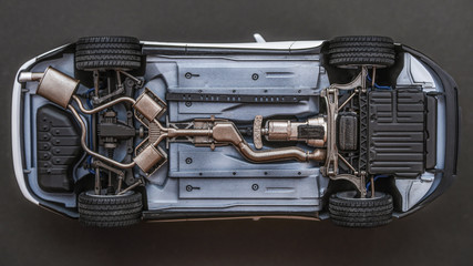 inverted car on a black background. bottom view of car