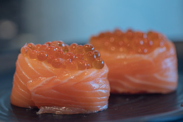 Close up Salmon Ikura Gunkan sushi.A popular Japanese food made of the basic ingredients with rice seaweed accompanied by salmon and fish roe.