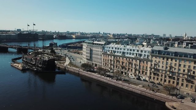 Aerial view of Russian cruiser Aurora near the bridge in Saint-Petersburg against blue sky. Stock footage. Petersburg landscape
