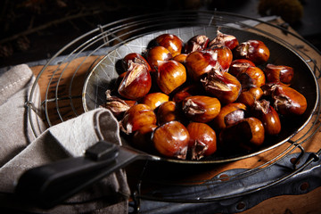 Pan of freshly roasted sweet chestnuts cooling