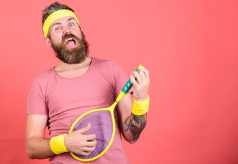 Man bearded hipster wear sport outfit. Having fun. Tennis active leisure. Athlete hipster hold tennis racket in hand red background. Tennis player vintage fashion. Tennis sport and entertainment