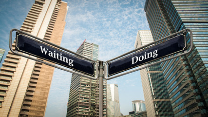 Fototapeta na wymiar Street Sign Doing versus Waiting
