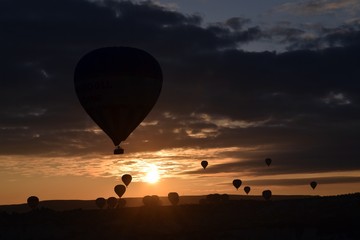 Sunrise and balloons. Beautiful background of the balloon and the sunset.Cappadocia. Turkey. Göreme. Nevşehir. Türkiye. 8. 04. 2019. Balloons flying over the rocky landscape in Cappadocia Turkey. View