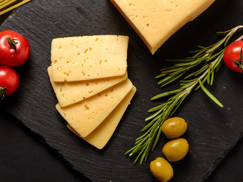 Hard cheese on a dark background