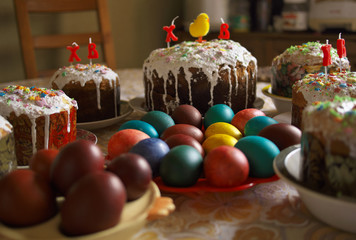 Traditional homemade iced Easter cakes kulich, with painted colored eggs, selective focus