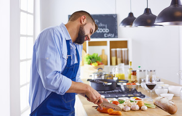 Young chef prepares a man in the kitchen