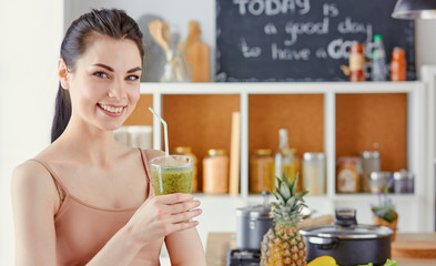 a young girl drinks a cocktail on a kitchen