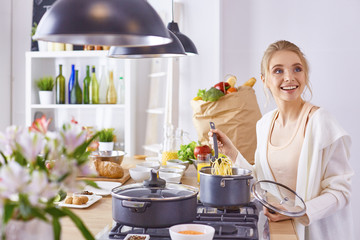 Young Woman Cooking in the kitchen. Healthy Food