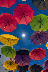Fototapeta na wymiar Display of Colorful Hanging Umbrellas with the Moon - Puerto Rico
