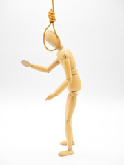 Miniature wooden doll with head in the noose of gallows isolated on white. Suicide concept with the hanging rope.