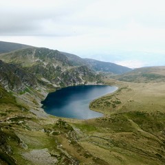 Fototapeta na wymiar Deserted hiking trail, empty beauty spot in Bulgaria, Eastern Europe, beautiful still lake surrounded by green rocky landscape, Rila lakes, trekking route