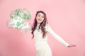 Young girl with balls on a colored background