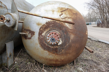 Close up background of rusty metal tank with rusty circular hole.