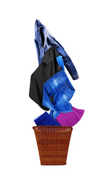 Clothing is flying from the basket on a white background