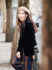 Beautiful young brunette woman looking and smiling with blur street background. Outdoor fashion portrait of glamour Chinese cheerful stylish lady. Emotions, people, beauty and lifestyle concept