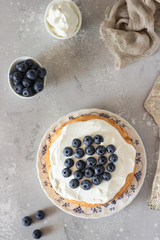 Angel food cake with whipped cream and fresh blueberries. 
