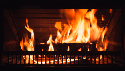 Fireplace burning at night, close up