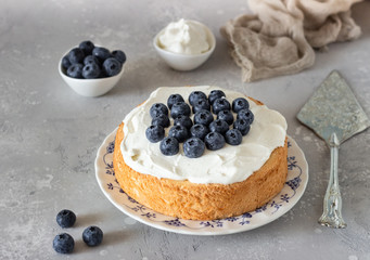 Angel food cake with whipped cream and fresh blueberries. 