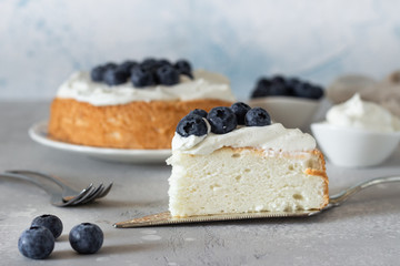 Angel food cake with whipped cream and fresh blueberries. 