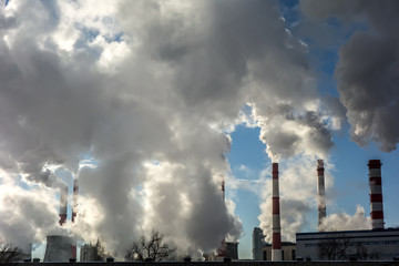 Steaming smoke stack and cooling tower with pollution