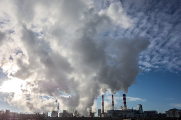 Steaming smoke stack and cooling tower with pollution