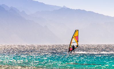 windsurfer rides on a background of high mountains in Egypt Dahab South Sinai