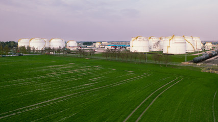 Fototapeta na wymiar Aerial view on refineries oil big tanks and train transfering station.