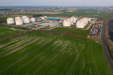 Aerial view on refineries oil big tanks and train transfering station.