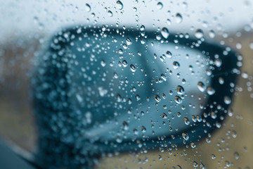 Raindrops on the side window of the car
