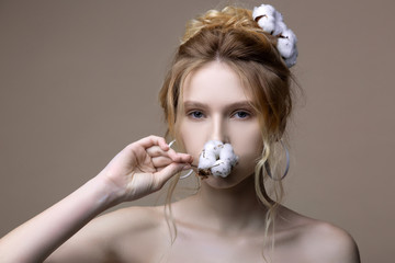 Tender appealing model with open shoulders posing with cotton