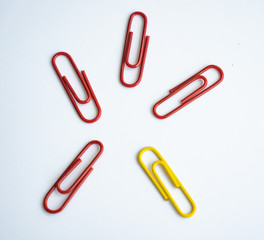 colored clips scattered on white background, form some pattern