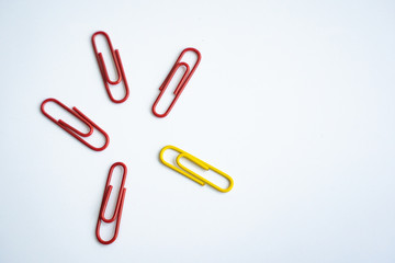 colored clips scattered on white background, form some pattern