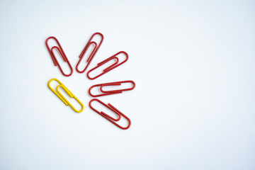 colored clips scattered on white background, form some pattern