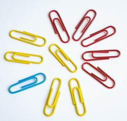 colored clips scattered on white background, form some pattern