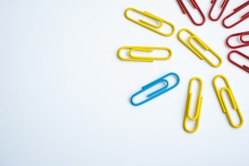 colored clips scattered on white background, form some pattern