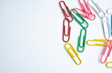 colored clips scattered randomly on white background