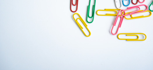colored clips scattered randomly on white background