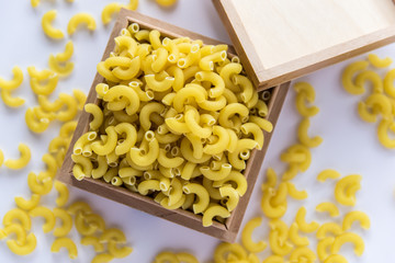 Uncooked pasta on white bachground.