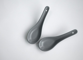 grey color chinese spoon made of ceramics，isolated in white background